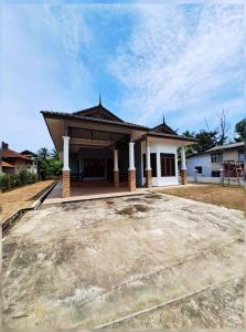 a house with a large driveway in front of it at ZN Homestay Gong Badak in Kampong Pengkalan Maras
