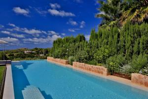 a swimming pool in the backyard of a house at Contemporary Ibizan Villa Cala Conta Dream Short Walk to Beach San Jose in Cala Comte