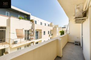 an apartment balcony with a view of buildings at Sunny & beautiful views, Amazing Design & Terrace by 360 Estates in Lija