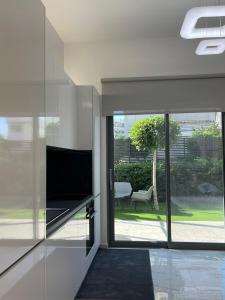 A television and/or entertainment centre at The Lop Athens Holidays Luxury Suites