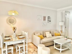 a living room with a couch and a table at Marbella Old Town-300m from the beach in Marbella
