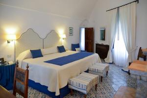 a hotel room with two beds and a table at Hotel Villa Cimbrone in Ravello