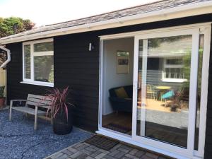 a sliding glass door on the side of a house at The Bay Cabin, secluded retreat Freshwater Bay in Freshwater