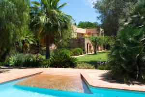 ein Swimmingpool vor einem Haus in der Unterkunft Exquisite Ibiza Villa I Secluded Hillside Location I Casa Jardin I 6 Bedrooms in San Jose de sa Talaia
