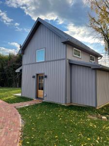 a large metal building with a garage at A newly built Tiny House in the center of Historic Kennett Square in Kennett Square
