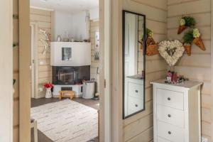 a kitchen with white cabinets and a fireplace at Majestic 3 Bedroom Villa With Sauna in Rovaniemi +23 photos