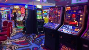a casino with several slot machines in a room at TM18 - 3 Bedroom Mobile Home Golden Palms Resort TV`s in Every Room Decking Indoor Heated Pool Entertainment complex & Close To Beaches PASSES NOT INCLUDED in Skegness