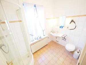 a bathroom with a shower and a toilet and a sink at Haus Neptun App. 4 in Westerland (Sylt) +7 photos
