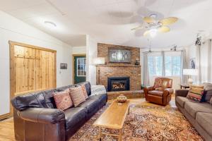 a living room with a couch and a fireplace at Riverbend in Joseph