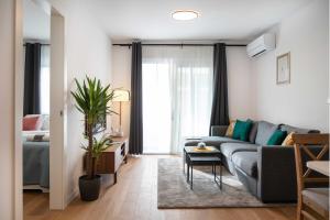 a living room with a couch and a bed at Design 2BDR Apartment with Balcony- FREE PARKING in Zagreb