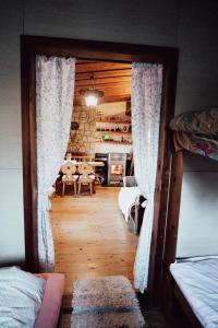 a view of a room with two beds and a kitchen at chata u Tesáku in Rajnochovice