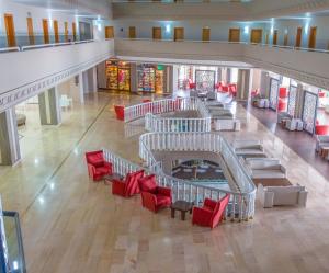 an overhead view of a lobby with red chairs and tables at LADONIA HOTELS ADAKULE in Aydın