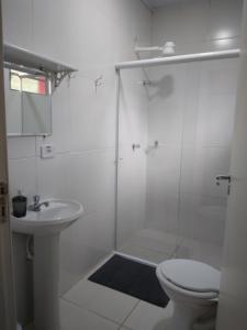 a bathroom with a shower and a toilet and a sink at Pousada da Serra Petar in Iporanga