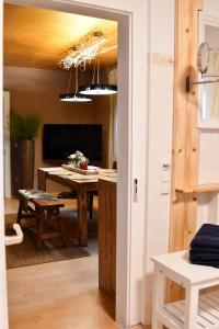 a dining room with a table and a television at Heimat Floral Ferienwohnung in Wadgassen
