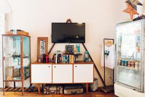 a living room with a tv and a white cabinet at Discovery Hostel in Rio de Janeiro +31 photos