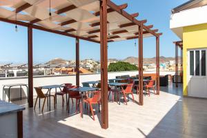 a group of tables and chairs on a patio at Santa Cruz Boutique Hotel in Mindelo
