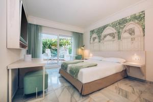 a hotel room with a bed and a balcony at Iberostar Selection Marbella Coral Beach in Marbella