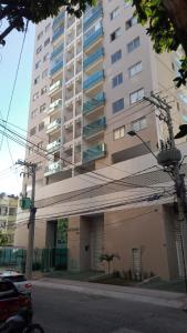 a large apartment building with a building at Lindo AP na Praia da Costa melhor bairro da cidade in Vila Velha