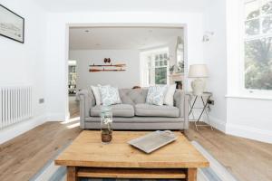 a living room with a couch and a coffee table at Woodvale Retreat in Harpsden