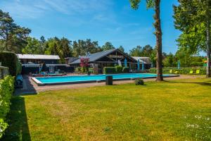 a yard with a pool and a house at Europarcs De Wije Werelt in Otterlo