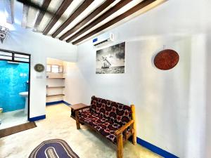 a living room with a couch in a room at Chikachika Beach B&B in Nungwi