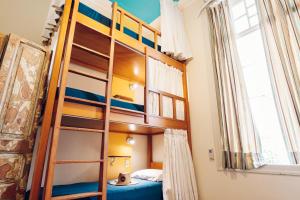 a bunk bed with a ladder in a room at Discovery Hostel in Rio de Janeiro