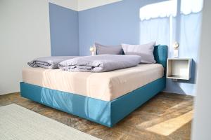 a bedroom with a bed with a blue wall at Kulturfabrik Schönbach in Schönbach +40 photos