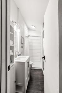 a white bathroom with a sink and a tub at Sky High Cabin in Bryson City in Bryson City