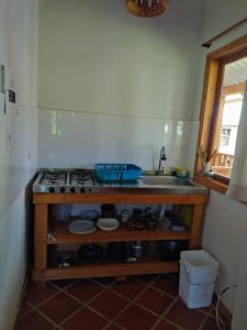 a kitchen with a stove and a sink at Sol y Luna Villa Campestre in Iza