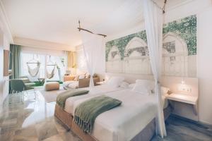 a bedroom with a large bed and a living room at Iberostar Selection Marbella Coral Beach in Marbella