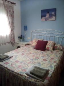 a bedroom with a bed with a quilt on it at CASA CARMEN in Calpe