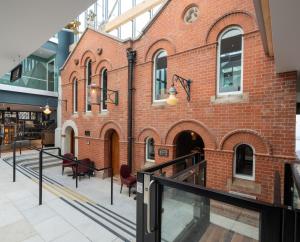 a red brick building with a glass railing in front of it at Keavan's Port Hotel , Dublin in Dublin