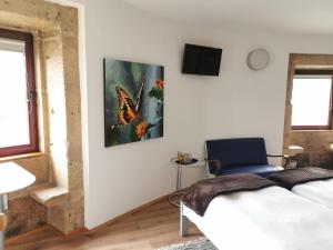 a living room with a butterfly painting on the wall at Bridge It - Suites & Views in Vila Nova de Gaia