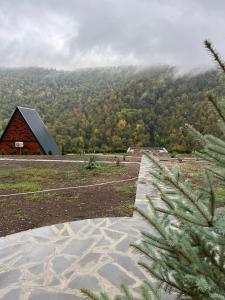 a view of a barn and a mountain at Green Villa Resort Small Gray in Dilijan