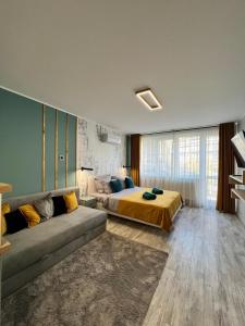 a large bedroom with a bed and a couch at AAB Studio Central in Piatra Neamţ