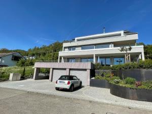 a car parked in front of a house at Bodensee-Apartment SeeSucht No 86 in Bodman-Ludwigshafen