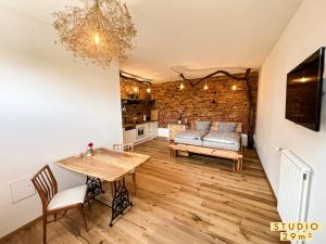 a living room with a table and a couch at Altstadt Apartments in Neuruppin