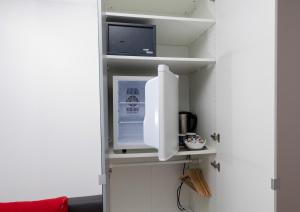 a refrigerator with its door open in a room at Haus Mayerhofer in Sankt Gilgen