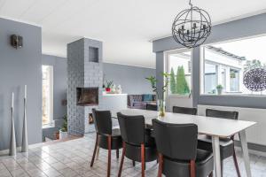 a kitchen and dining room with a table and chairs at Spacious villa in Upplands Vasby in Upplands-Väsby