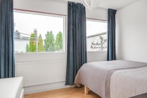 a bedroom with a bed and a large window at Spacious villa in Upplands Vasby in Upplands-Väsby