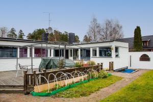 a house with a deck and some plants on it at Spacious villa in Upplands Vasby in Upplands-Väsby
