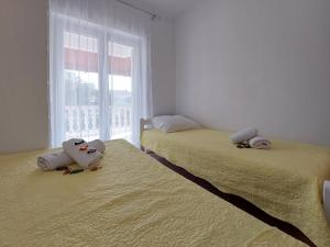 Postel nebo postele na pokoji v ubytování Apartments Nono