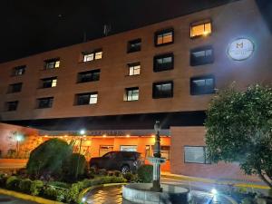 a building with a truck parked in front of it at Hotel Morasurco in Pasto