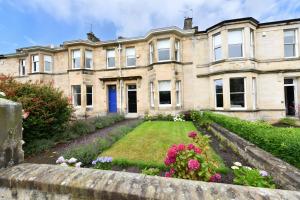 an old house with a garden in front of it at The Old Manse in Ayr