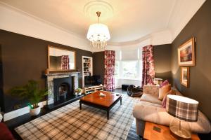 a living room with a couch and a fireplace at The Old Manse in Ayr