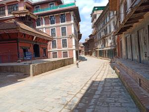 a person walking down a street in a city at Big Bell Guest House in Bhaktapur