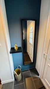 a bathroom with a mirror on a blue wall at LA VILLA DEKO - Studio avec parking proche Université et Hôpital in Beuvry
