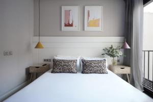 a bedroom with a large white bed with two pillows at numa I Brio in Barcelona