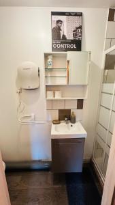 a small bathroom with a sink and a mirror at LA VILLA DEKO - Studio avec parking proche Université et Hôpital in Beuvry