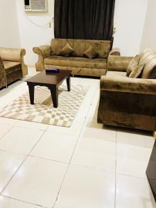 a living room with two couches and a coffee table at ركن الهدوء in Muhayil